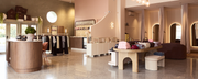 Photograph of the inside of a retail space showing the counter, clothing racks and change rooms